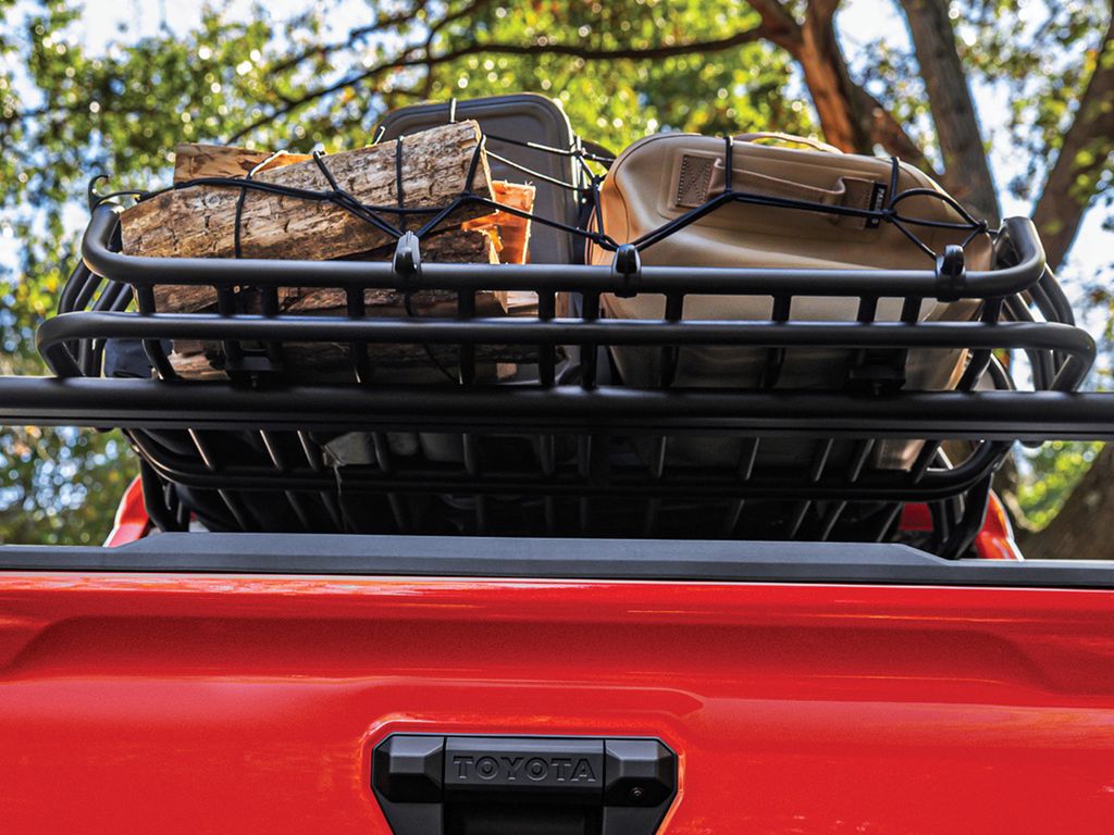 RealTruck Elevate Cargo Basket on a roof rack carrying logs and a cooler.